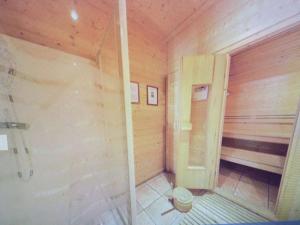 a small room with a shower in a wooden house at Chalet individuel, piscine sauna in Le Dévoluy