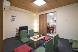 a living room with a table and chairs and a dining room at Fukugenkaku - Vacation STAY 14218 in Osaka