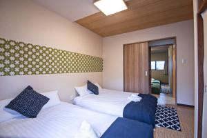 a hotel room with two beds and a hallway at Fukugenkaku - Vacation STAY 14218 in Osaka