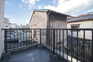 a balcony with a black railing and a building at Fukugenkaku - Vacation STAY 14218 in Osaka