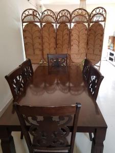 a dining room table with four chairs and a table and chairsearcher at Ak22 stays Bardhaman Burdwan in Barddhamān