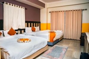Postel nebo postele na pokoji v ubytování Hotel Kamana