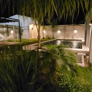 a swimming pool with a palm tree in a yard at Moderna casa en San Bernardino!! in San Bernardino