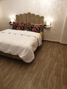 a bedroom with a large bed and a wooden floor at Holikeys - Marrakech - 2 Ch - Targa 006 in Marrakesh