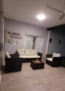 a living room with a couch and two chairs at Moderna casa en San Bernardino!! in San Bernardino
