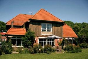 a large house with an orange roof at Lindenallee 4a - Erholung und Wellness in Westfehmarn