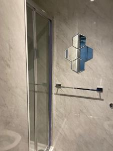 a shower in a bathroom with a glass door at Holiday Plus - Holmfield Road in Blackpool