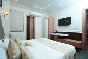 a hotel room with a bed and a television at Anaya Retreat in Varanasi