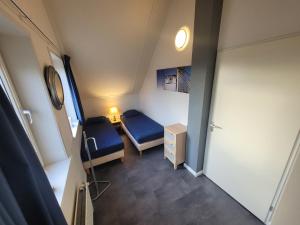 a small room with two beds and a cabinet at Antibes 248 - Kustpark Village Scaldia in Hoofdplaat