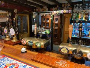 a bar with bottles of beer on the counter at Lovely peaceful 2 bed cottage in Llandderfel