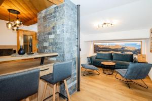 a living room with a couch and a table and chairs at Ferienparadies Taxen in Sankt Veit im Pongau