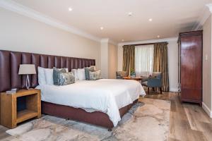 a bedroom with a large bed with a leather headboard at Clico Boutique Hotel in Johannesburg