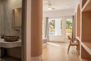 a bathroom with a sink and a window at Aloni Hotel & Suites in Piso Livadi