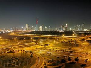 a city lit up at night with buildings in the background at Burj Khalifa & City Skyline View, Full Furnish Studio in Dubai