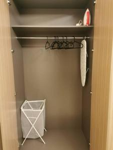 a closet with a door open with a towel and a white organizer at Burj Khalifa & City Skyline View, Full Furnish Studio in Dubai