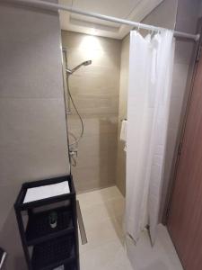 a bathroom with a shower with a shower curtain at Burj Khalifa & City Skyline View, Full Furnish Studio in Dubai