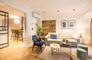 a living room with a couch and chairs and a table at Edmond Vibes Puerta del Sol Suites in Madrid
