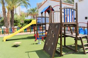 a playground with a slide in a park at COZY BUNGLOW RINCONDA REAL in Benidorm