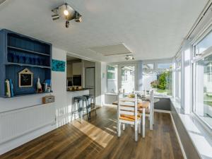 a kitchen and dining room with a table and chairs at 2 Bed in Bude 90312 in Bude