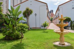 a park with a fountain in the grass at COZY BUNGLOW RINCONDA REAL in Benidorm