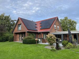 a house with solar panels on the roof at !!!NEU!!! FEWO Sanna in Dornum