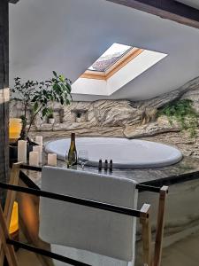 a bathroom with a bath tub with a sink at Еко Комплекс Албиция in Gospodinovo