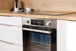 a kitchen with a black oven and a counter at Residence Morris Mladá Boleslav in Mladá Boleslav