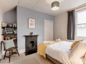 a bedroom with a bed and a fireplace at 4 Bed in Wylam 90433 in Wylam