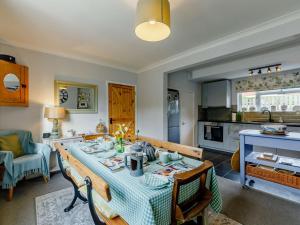 a kitchen and dining room with a table and chairs at 3 Bed in Bamburgh 90351 in Belford