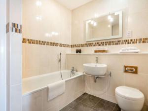 a white bathroom with a sink and a toilet at 2 bed in Brightlingsea 90382 in Saint Osyth