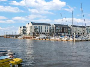 a marina with boats in the water and buildings at 2 bed in Brightlingsea 90382 in Saint Osyth