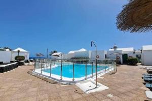 a swimming pool in the middle of a resort at Costa Gaviotas Bungalow in Puerto del Carmen