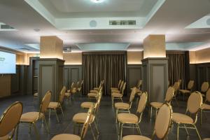 a conference room with chairs and a projection screen at Hotel Palace in Catanzaro Lido