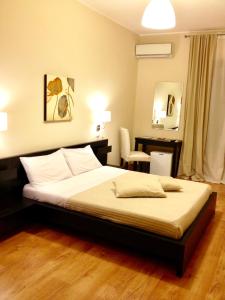 a bedroom with a bed and a desk in it at Bella Cagliari B&B in Cagliari