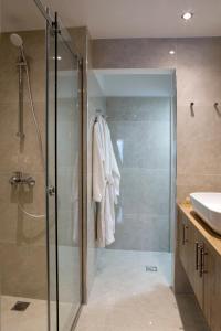 y baño con ducha acristalada y lavamanos. en La Residence Athens M2 & M3, en Atenas