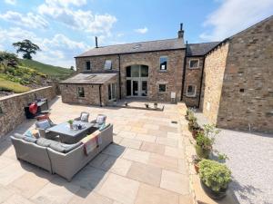 a patio in front of a brick building at 5 Bed in Ingleton 90546 in Burton in Lonsdale