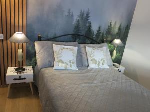 a bedroom with a bed with two pillows at Sibiu Cigalyne in Cristian