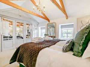 a bedroom with a large bed and a chandelier at 2 Bed in Hayle 90552 in Phillack