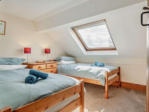 a bedroom with two beds and a window at 4 Bed in Hay on Wye 90375 in Builth Wells