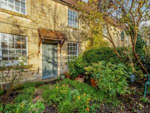 a brick house with a door and some plants at 2 Bed in Bath 90431 in Wingfield