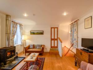 a living room with a couch and a television at 3 Bed in Argyll Bute 90478 in Tighnabruaich