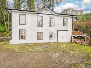 a large white house with a garage at 3 Bed in Argyll Bute 90478 in Tighnabruaich