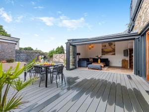 a patio with a table and chairs on a wooden deck at 3 Bed in Brixham 90614 in Brixham