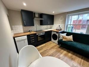 a living room with a couch and a kitchen at 1 Bed in Fakenham 90683 in Fakenham