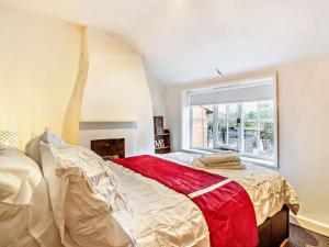 a bedroom with a large bed and a window at 2 Bed in Needham Market 90561 in Stowmarket
