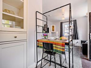 a kitchen with a table with a colorful blanket on it at 1 Bed in Keswick 90646 in Keswick