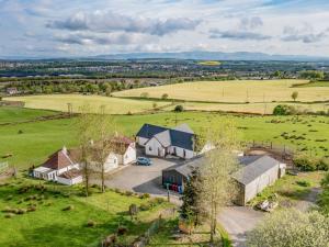 an aerial view of a house in a field at 2 Bed in Falkirk 90602 in Bonnybridge