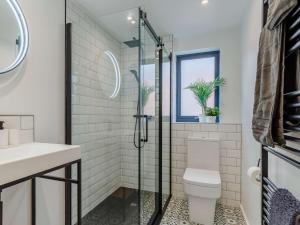 a bathroom with a toilet and a glass shower at 3 bed property in Holsworthy 90721 in Holsworthy