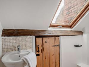 a bathroom with a sink and a skylight at 2 Bed in Slimbridge 90719 in Cambridge