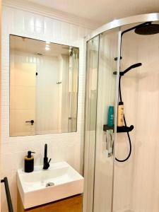 a bathroom with a sink and a shower with a mirror at Portamar estudio 312 in Almuñécar +18 photos